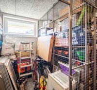 A storage space with network shelves and a lot of stored items in a 2-room apartment.