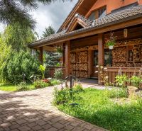 A family house in Veľká Lomnica with a garden, wood, and floral decorations.