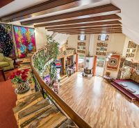 Colorful interior of a family house with a wood-patterned floor and decorative decorations.