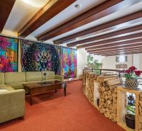 Living space in a family house with colorful tapestries and a comfortable seating area.