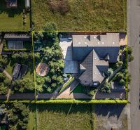 A family house in Veľká Lomnica surrounded by a garden with a gazebo and a driveway.