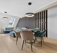 Living room in a 3-room apartment with a sofa, wooden decor flooring, and a table.