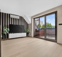 A living room in a 3-room apartment with a television and a wooden decor floor.