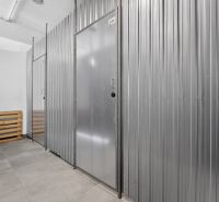 Sheet metal separated basement spaces in a 3-room apartment with tiled flooring.