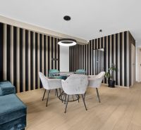 Living room with wood-patterned flooring and striped walls in a 3-room apartment.