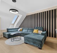 Living room with a sofa and wooden decor flooring in a 3-room apartment.