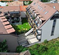 Garden and residential buildings on Halenárska Street in Trnava near a 3-room apartment.