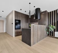 A kitchen corner in a 3-room apartment with a wooden decor floor and black details.