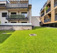 The exterior of an apartment building with balconies and a lawn on Halenárska Street in Trnava.