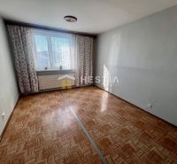 A room with a wooden decor floor in a 3-room apartment.