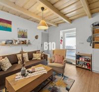 Living room in a family house with wooden decor and comfortable seating.