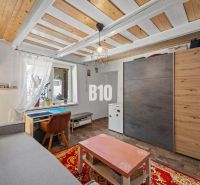 Living room of a family house with a floor and ceiling featuring a wooden decor.