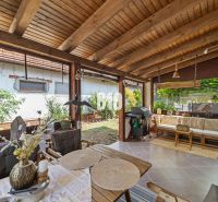 The terrace of a family house in Podhájska with garden furniture and a grill.