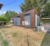 A family house in Podhájska with a garden, wooden gazebo, and air conditioning in the yard.
