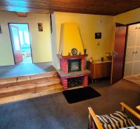 A family house with a fireplace and wooden stairs, a cozy interior with a living room.