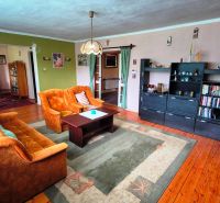 Living room in a family house with retro furniture and a wooden decor floor.