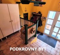 Entrance hall with tiles, wardrobe, and glass doors in a family house.