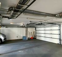 Garage with a car, tools, and a yellow pillar in the business premises of the Office.
