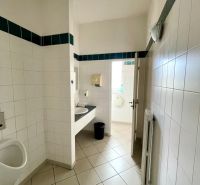Toilets in offices with tiled walls and floors.