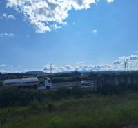 A truck on the highway surrounded by countryside near Ličartovce.