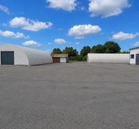 Warehouses and halls in Ličartovce with extensive paved areas and arched buildings.