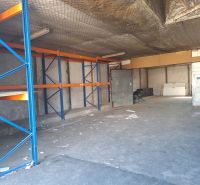 Warehouses and halls with empty shelves, concrete floor, and metal racks.