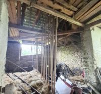 Interior in a family house with piles of hay in Dobroč.
