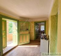 The interior of a family house with green doors and rustic furnishings.