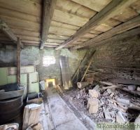 A rustic room in a family house with old tiles and wood.