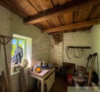 Wooden ceiling and antique tools in the interior of a family house.