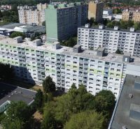 A view of residential blocks and greenery on Eisnerova Street in Bratislava, Devínska Nová Ves.