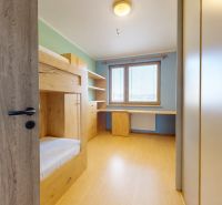 Children's room with a built-in bunk bed and a floor with a wooden decor in a 3-room apartment.