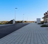 A row of family houses in Andovce, next to the renovated sidewalk and road infrastructure.