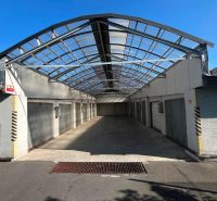 Garages on Púpavová Street in Bratislava - Karlova Ves with a transparent roof.