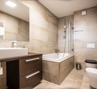 Luxury bathroom in a 2-room apartment with a large mirror and a bathtub.