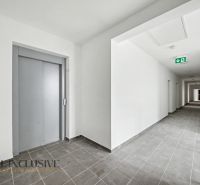 Hallway with an elevator and tiles in a 2-room apartment.