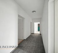 A bright hallway in a 2-room apartment with gray tiles and white walls.