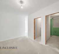 Interior of a 2-room apartment with bare walls and raw flooring.