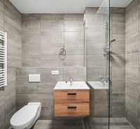 Bathroom in a 2-room apartment with tiles and a shower corner.