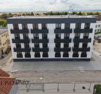 Apartment building with balconies and surrounding development in Zlaté Klasy.