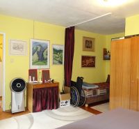Bedroom of a family house with furniture, wall decorations, and a wooden decor floor.