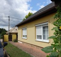A family house on the Third Row, Mojmírovce, with a sunflower in front of the facade.