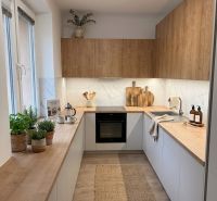 Kitchen in a 4-room apartment with storage space and flooring with a wood decor.