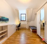 A room with a wooden floor decor, a writing desk, and a wardrobe in a five or more room apartment.