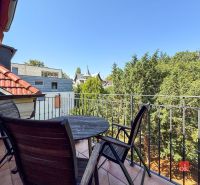 A balcony with a view of greenery in a 5 or more room apartment.