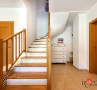 A staircase with a wooden railing and a floor with a wooden decor in a 5 or more room apartment.