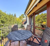 A terrace with wooden furniture, a view of greenery, access from a 5 or more room apartment.