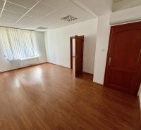 Windows and doors in an office with wood-patterned flooring and blinds.
