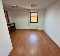 Offices with wood-patterned flooring, white walls, and a small window.