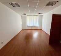 Offices with wood-patterned flooring, white walls, window with vertical blinds.